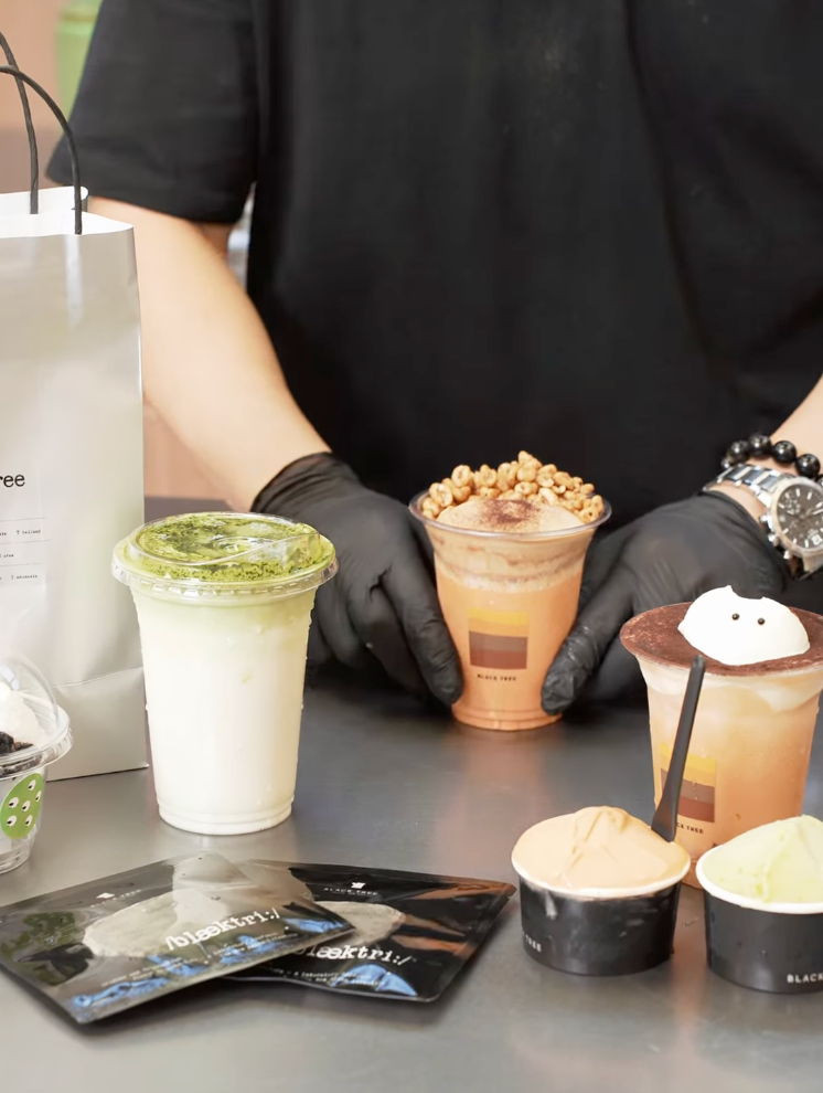Black Tree beverages and dessert products displayed at the counter